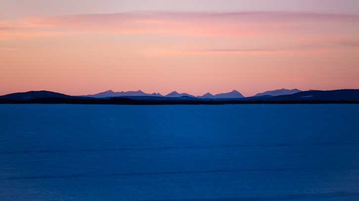 Distant mountains of frozen lake - Sweden